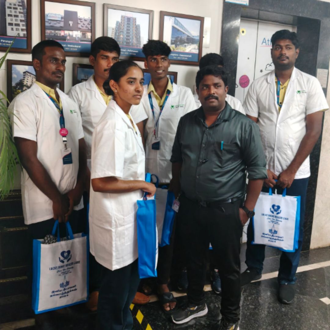 A Lucky Home Health Care nurse assisting a senior woman with mobility support at home in Chennai.