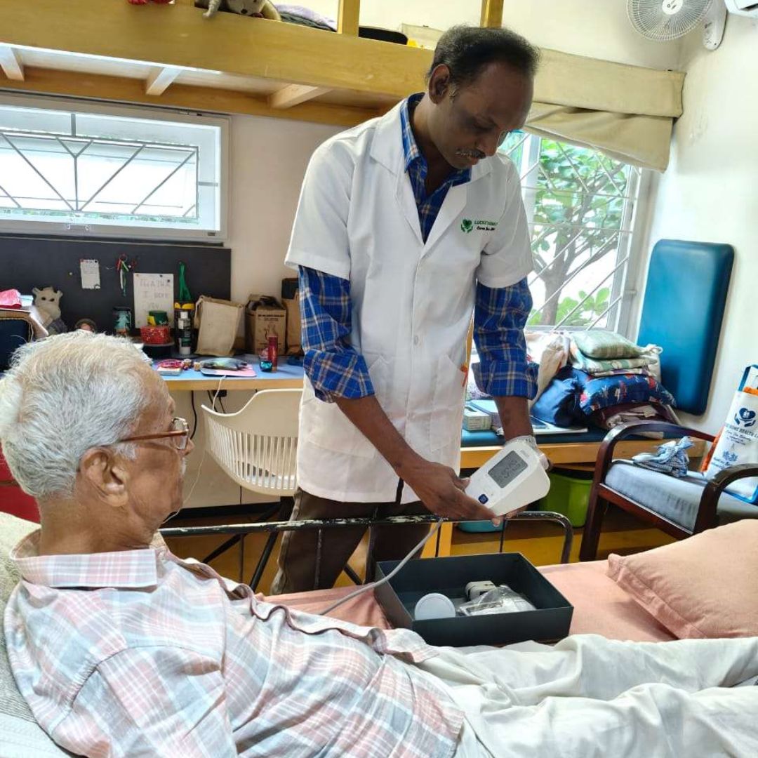 Lucky Home Health Care nurse assisting an elderly woman to walk safely during home care in Chennai.