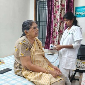 Doctor from Lucky Home Health Care counseling a senior and their family at home in Chennai about ongoing treatment.